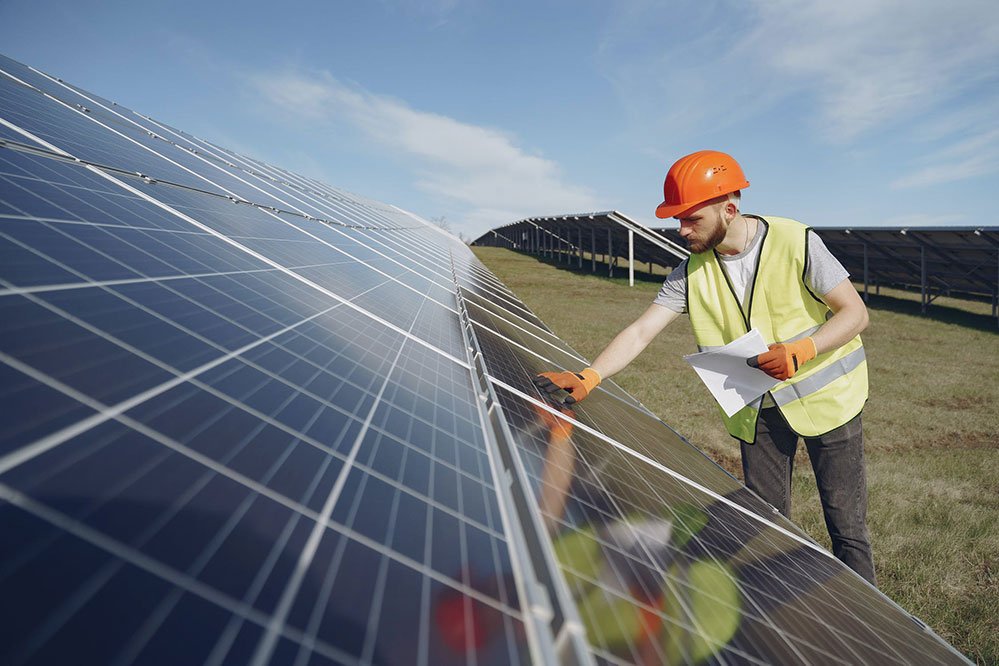 Engineer inspecting solar panel for maintenance.